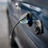 Voiture électrique bleue branchée à une borne de recharge