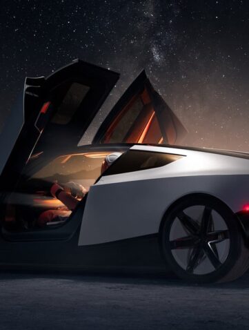 Nouveau Tesla Roadster blanc de nuit dans un décor désertique, portes ouvertes en élytre, vu de profil arrière (image officielle Tesla)