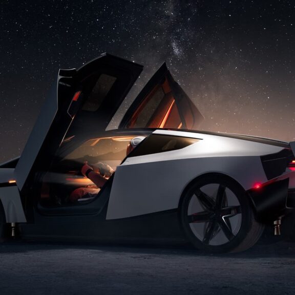 Nouveau Tesla Roadster blanc de nuit dans un décor désertique, portes ouvertes en élytre, vu de profil arrière (image officielle Tesla)