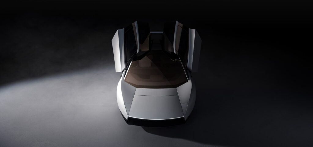 Tesla Roadster vu du dessus, portes ouvertes sur un habitacle clair (image officielle Tesla)